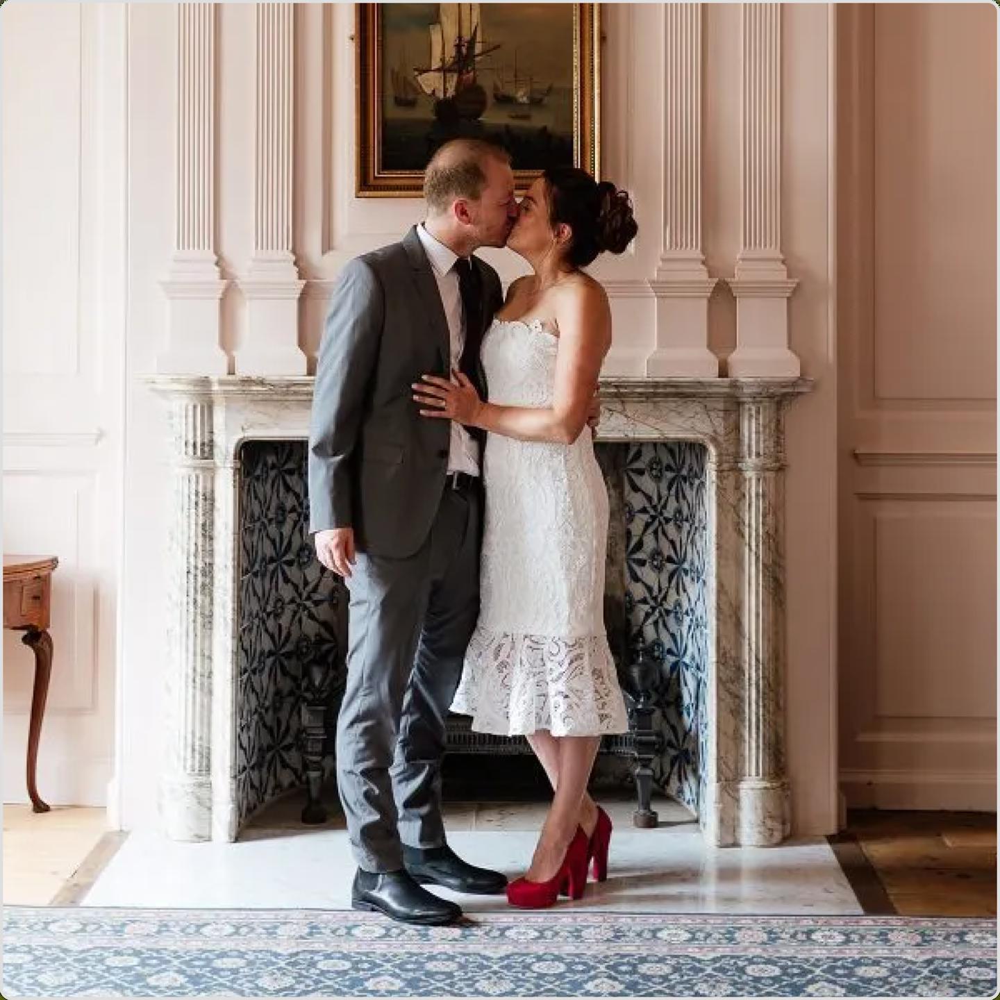 Wedding couple kiss in front of Georgian fireplace at 16 New Street