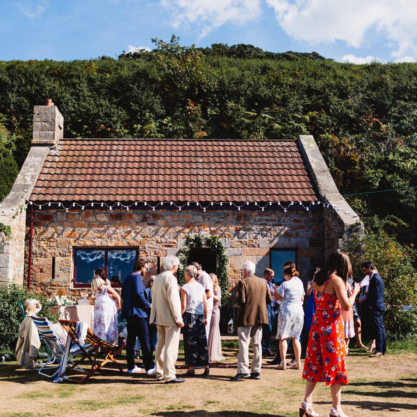 Le Catel Fort Jersey - granite building with crowd gathered around