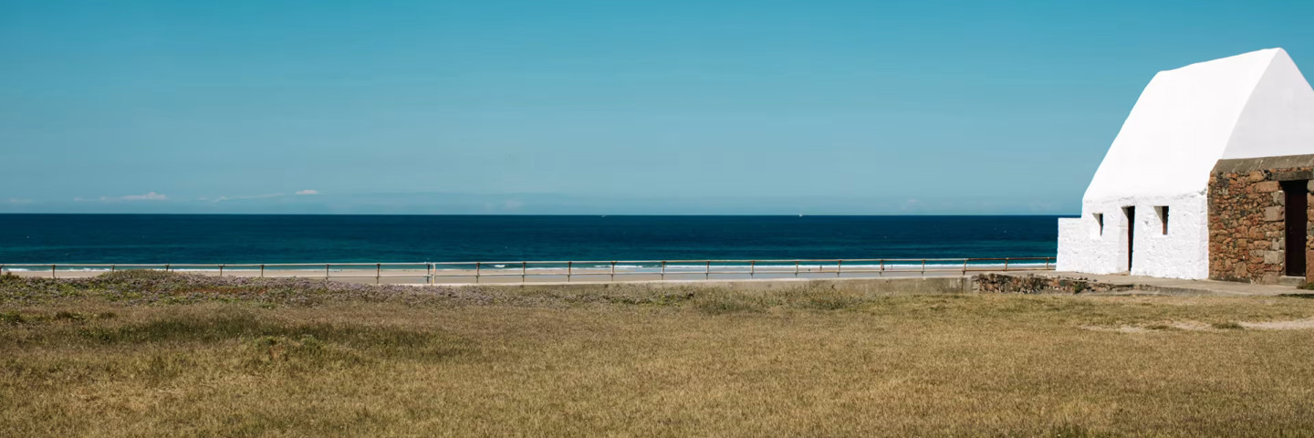 Le Don Hilton - National Trust for Jersey. White Cottage by the sea